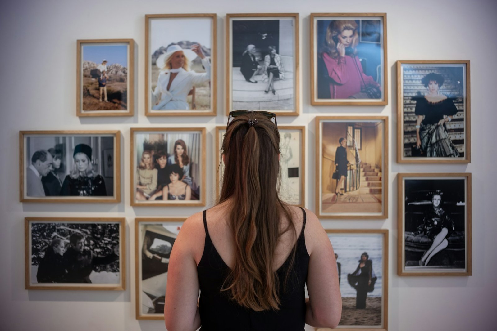 Visitor viewing a collection of framed photography in an art gallery