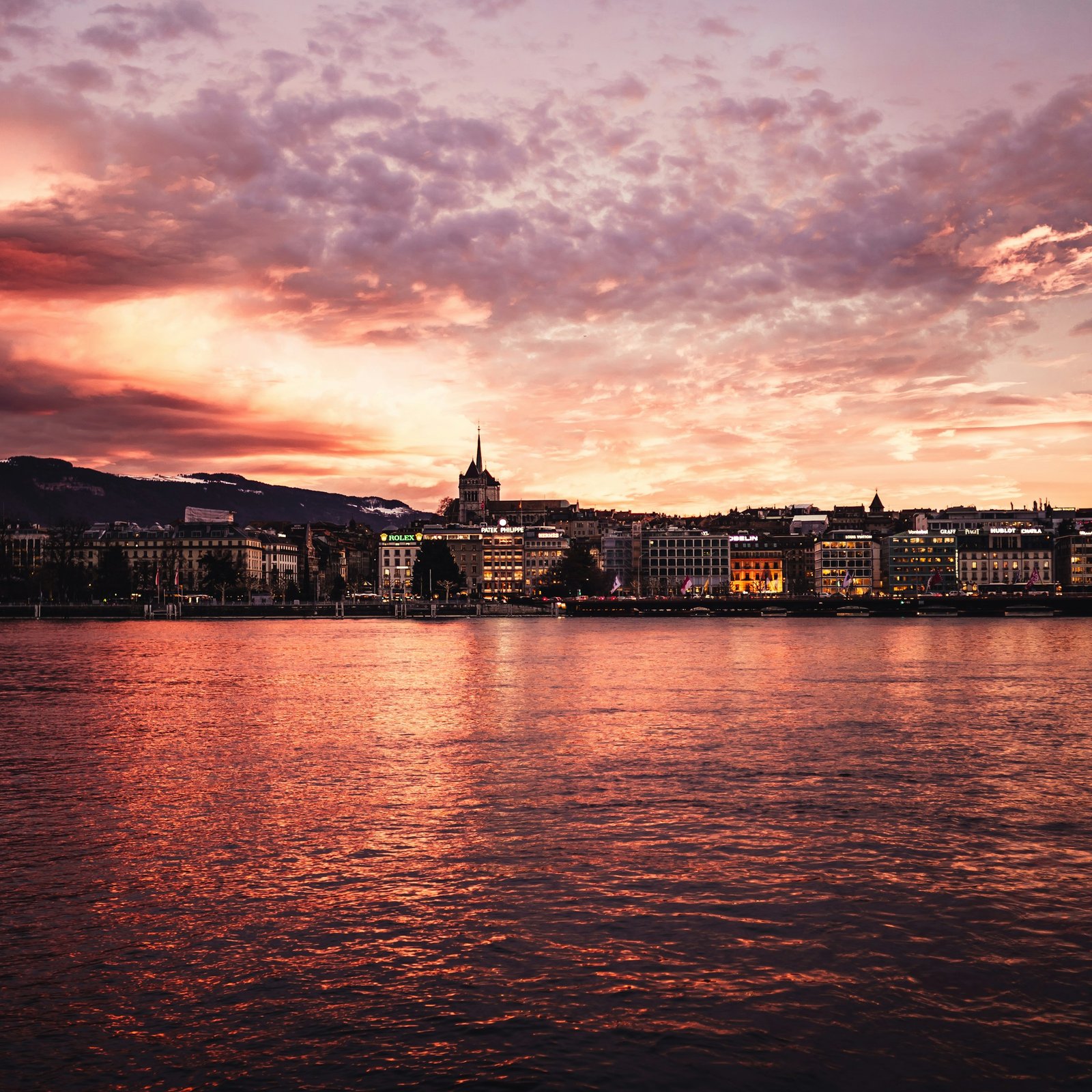 Geneva waterfront and historic buildings in warm evening light